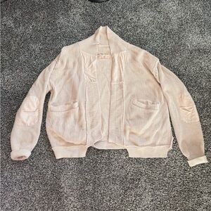 We the Free cardigan in a creamy color.